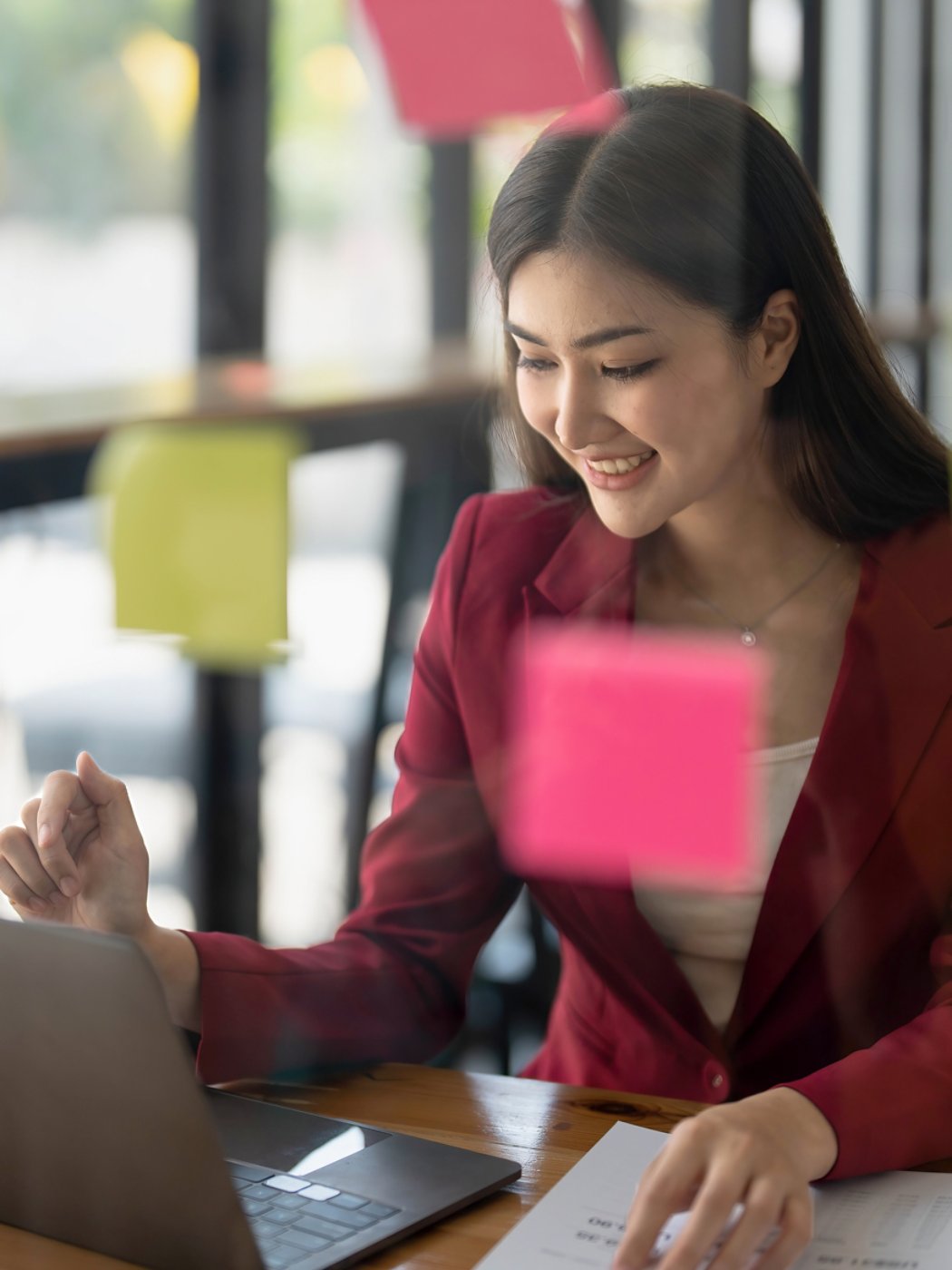 Young businesswoman creative team using post it notes in glass wall to writing strategy business plan to development grow to success...